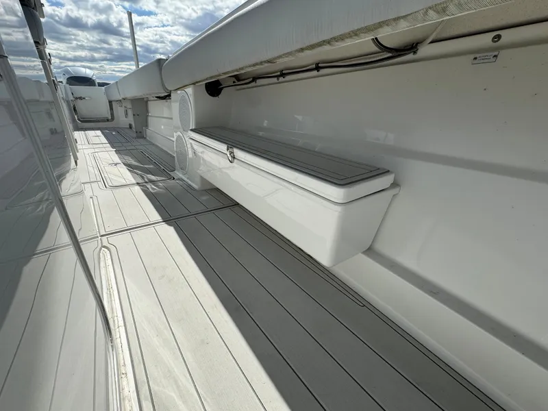 Slide: The Image of 2019 HCB Siesta boat deck with storage compartment and seating. - 24