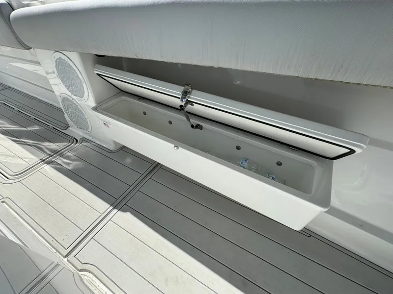 Slide: The Image of 2019 HCB Siesta boat with open storage compartment and speakers. - 25