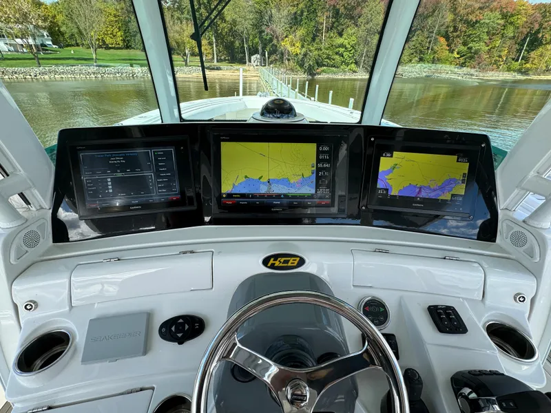 Slide: The Image of 2019 HCB Siesta boat dashboard with navigation screens and steering wheel. - 29