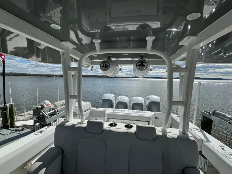 Slide: The Image of 2019 HCB Siesta boat with quad engines docked by the water. - 36