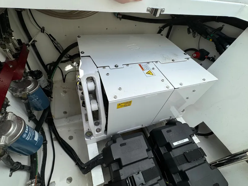 Slide: The Image of Engine compartment of a 2019 HCB Siesta boat with mechanical components. - 40