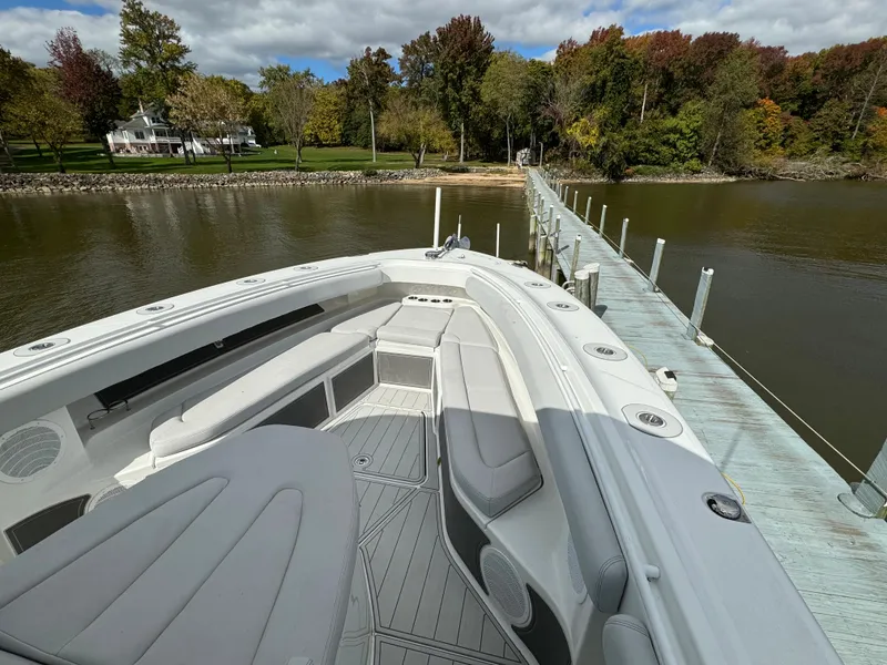 Slide: The Image of 2019 HCB Siesta boat docked at a serene lakeside pier with autumn foliage. - 47