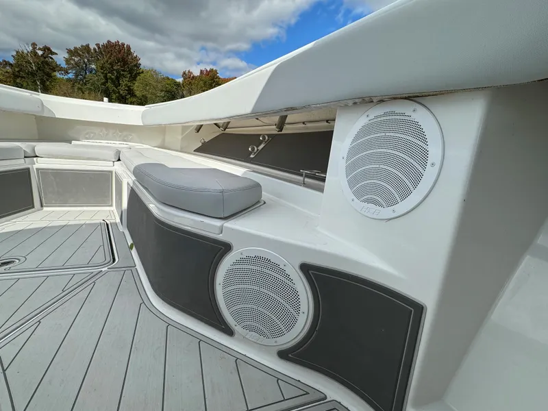 Slide: The Image of 2019 HCB Siesta boat interior with speakers and cushioned seating. - 48