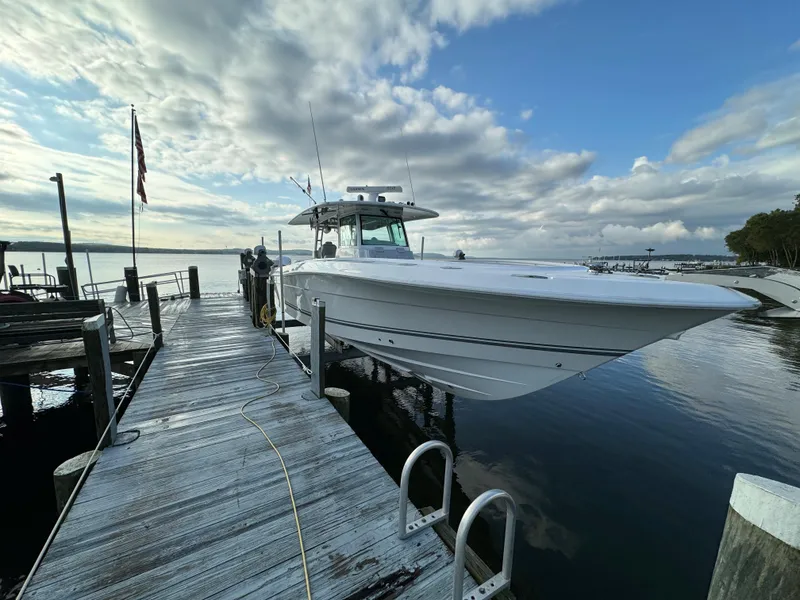 Slide: The Image of 2019 HCB Siesta boat docked at a marina under a cloudy sky. - 7