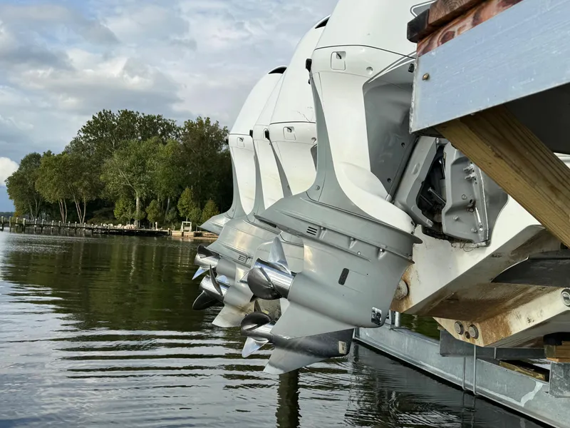 Slide: The Image of Close-up of 2019 HCB Siesta boat engines on a dock by a lake. - 9