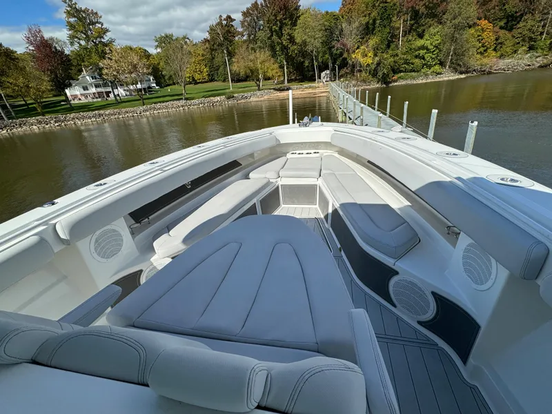 Slide: The Image of 2019 HCB Siesta boat with luxurious seating, docked by a scenic riverside. - 21