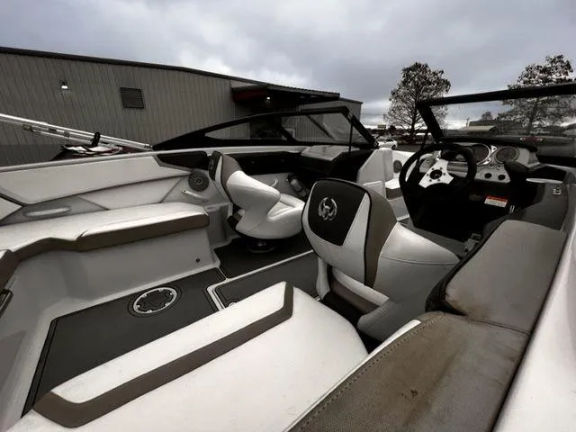 Slide: The Image of Interior of a 2014 Scarab 215 boat with modern seating and dashboard. - 10