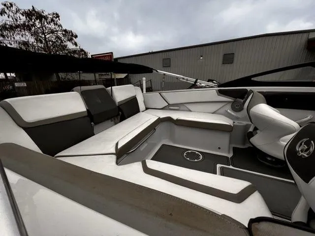 Slide: The Image of 2014 Scarab 215 boat interior with white and gray seating. - 11