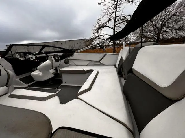 Slide: The Image of Interior of a 2014 Scarab 215 boat with white and gray seating. - 13