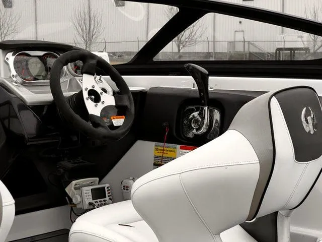 Slide: The Image of 2014 Scarab 215 boat interior, steering wheel, and control panel. - 14