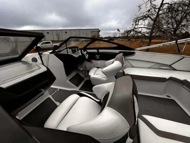 Slide: The Image of 2014 Scarab 215 boat interior with white and black seating. - 15