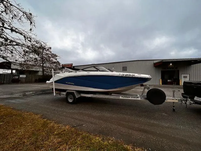 Slide: The Image of 2014 Scarab 215 boat on a trailer in an industrial area. - 6