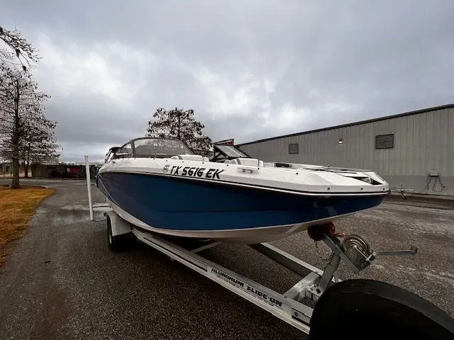 Slide: The Image of 2014 Scarab 215 boat on a trailer in an industrial area. - 7