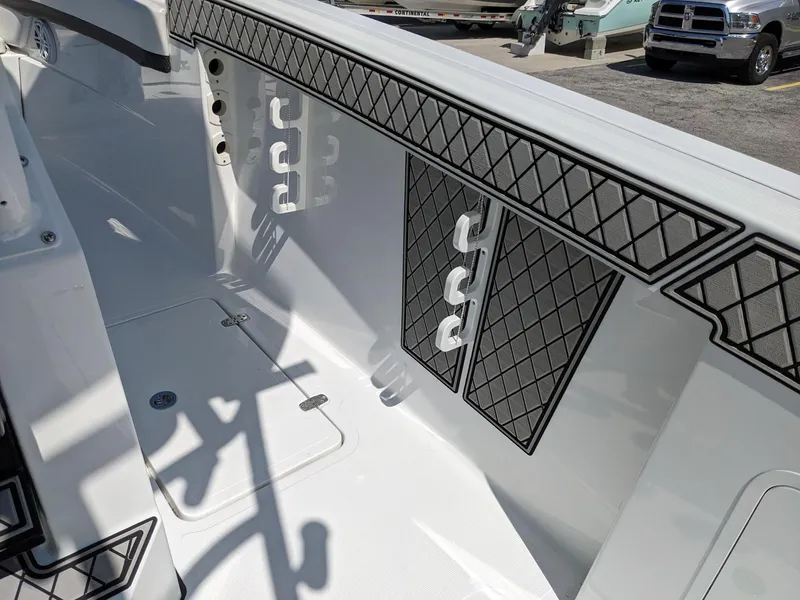 Slide: The Image of 2024 Wellcraft 302 Fisherman boat interior with rod holders and storage compartments. - 11