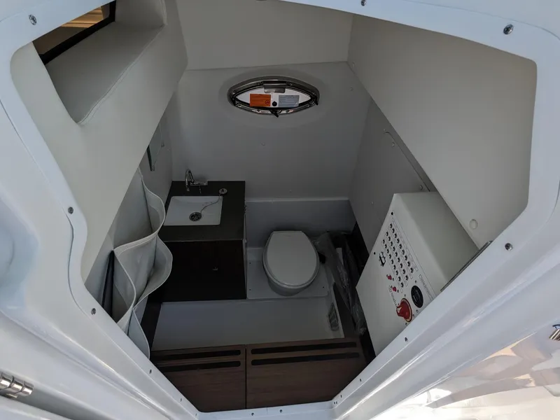 Slide: The Image of 2024 Wellcraft 302 Fisherman boat interior with toilet and sink. - 12