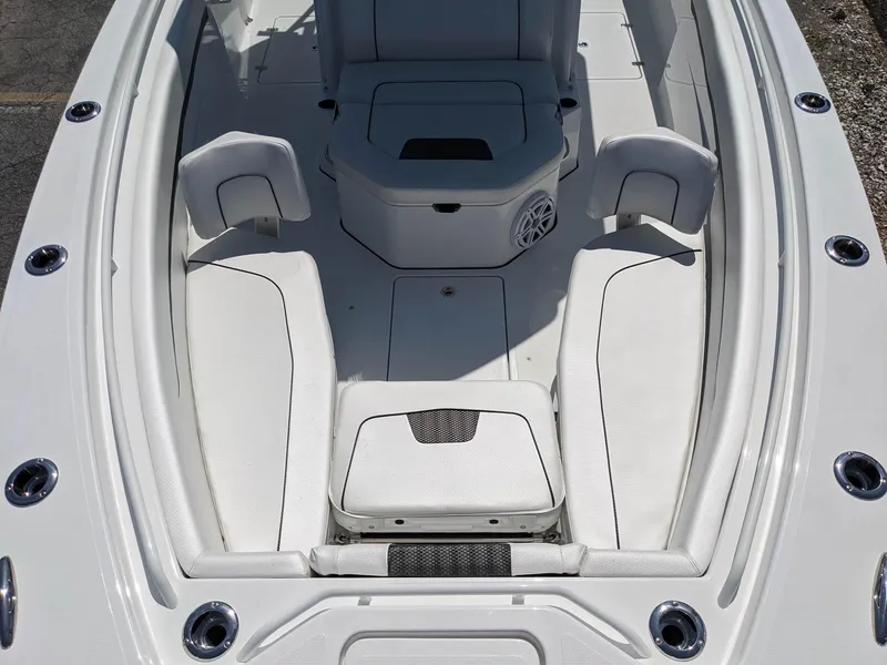 Slide: The Image of 2024 Wellcraft 302 Fisherman boat interior with white seating and storage compartments. - 19