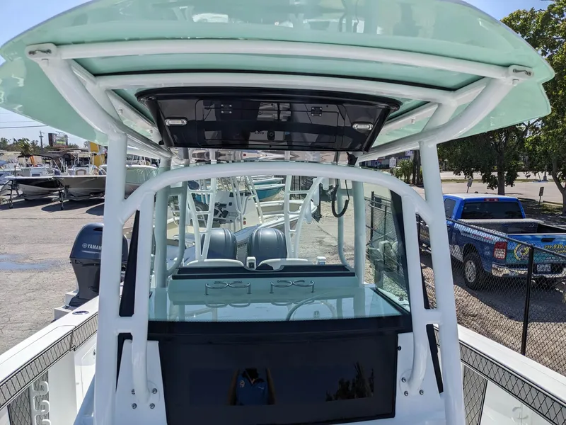 Slide: The Image of 2024 Wellcraft 302 Fisherman boat, center console view, docked at marina. - 23