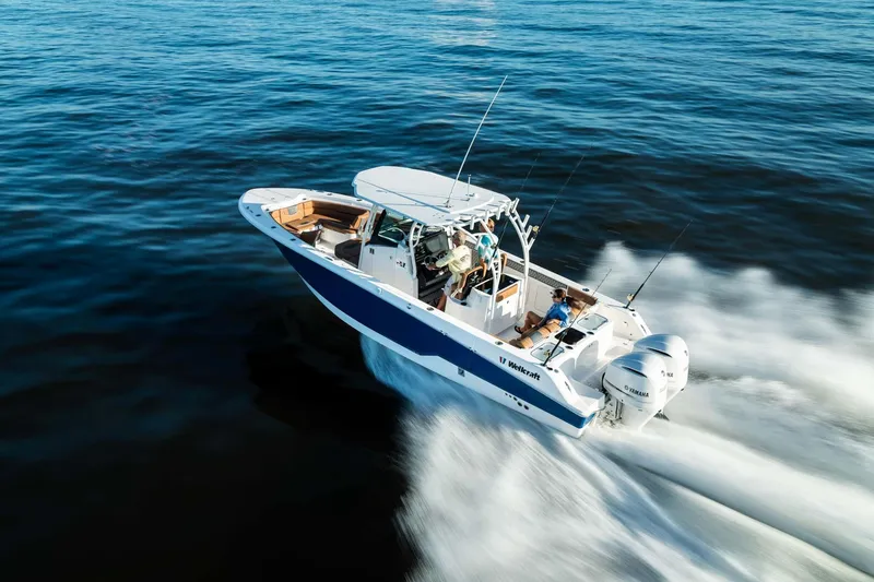 Slide: The Image of 2024 Wellcraft 302 Fisherman boat cruising on open water. - 24