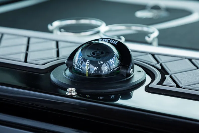 Slide: The Image of Close-up of a compass on a 2024 Wellcraft 302 Fisherman boat. - 25