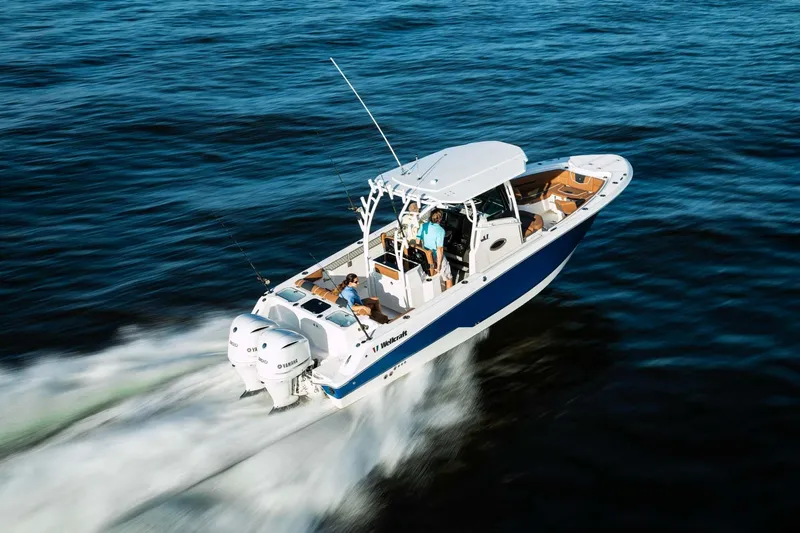 Slide: The Image of 2024 Wellcraft 302 Fisherman boat cruising on open water. - 29