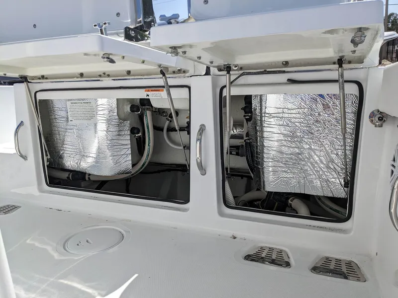 Slide: The Image of 2024 Wellcraft 302 Fisherman boat storage compartments open. - 3