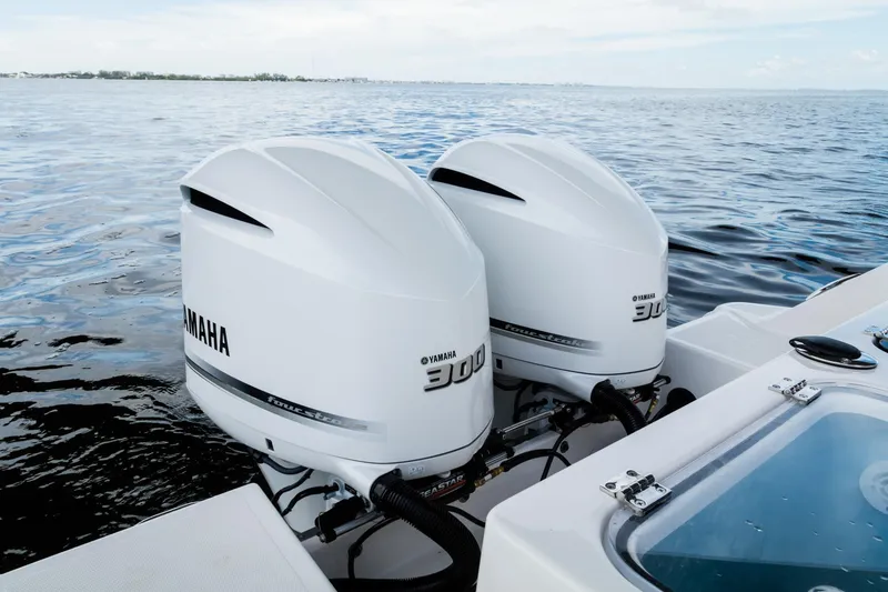 Slide: The Image of 2024 Wellcraft 302 Fisherman with twin Yamaha 300 outboard engines on the water. - 30
