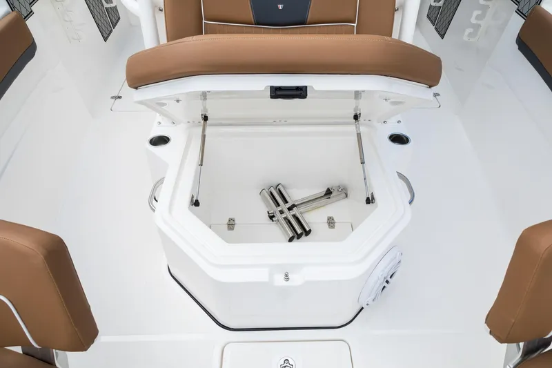 Slide: The Image of 2024 Wellcraft 302 Fisherman boat storage compartment with open lid and brown seating. - 39
