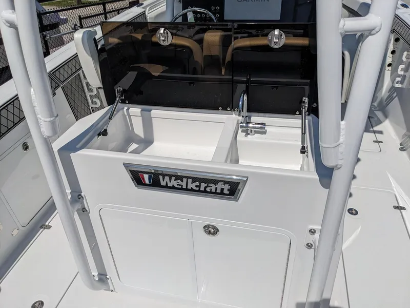 Slide: The Image of 2024 Wellcraft 302 Fisherman boat interior with storage compartments. - 4