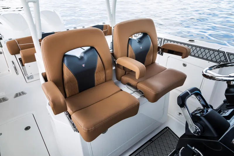 Slide: The Image of 2024 Wellcraft 302 Fisherman boat with luxurious tan and black captain seats. - 42
