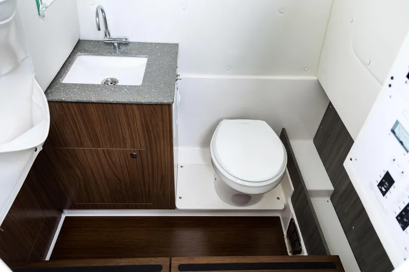 Slide: The Image of 2024 Wellcraft 302 Fisherman boat bathroom with sink and toilet. - 48