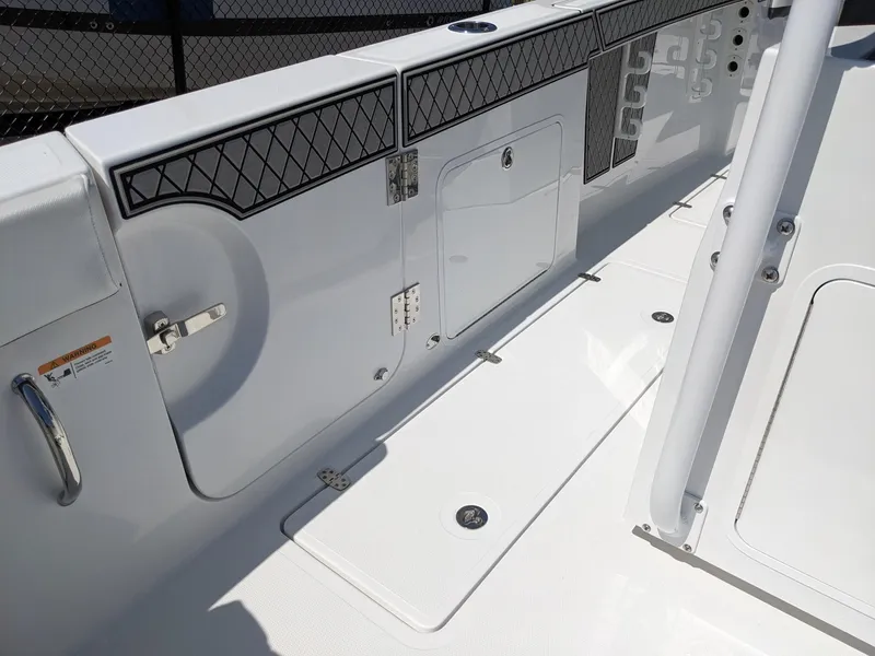 Slide: The Image of 2024 Wellcraft 302 Fisherman boat deck with storage compartments and rod holders. - 5