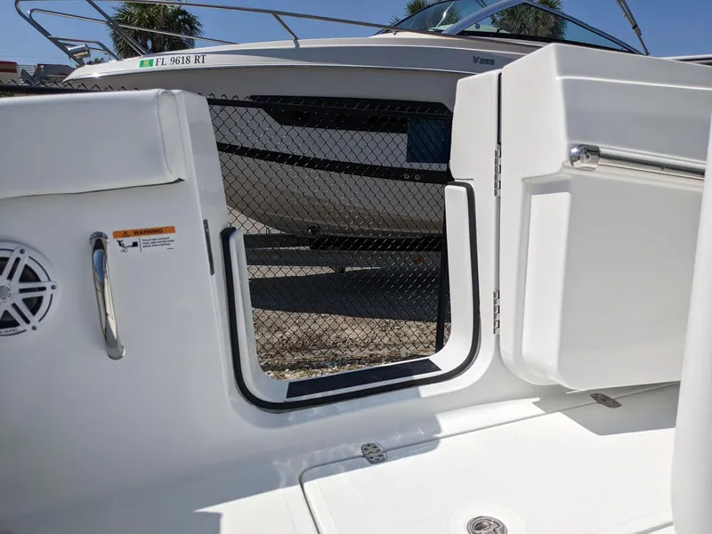 Slide: The Image of 2024 Wellcraft 302 Fisherman boat interior with open side door and safety net. - 6