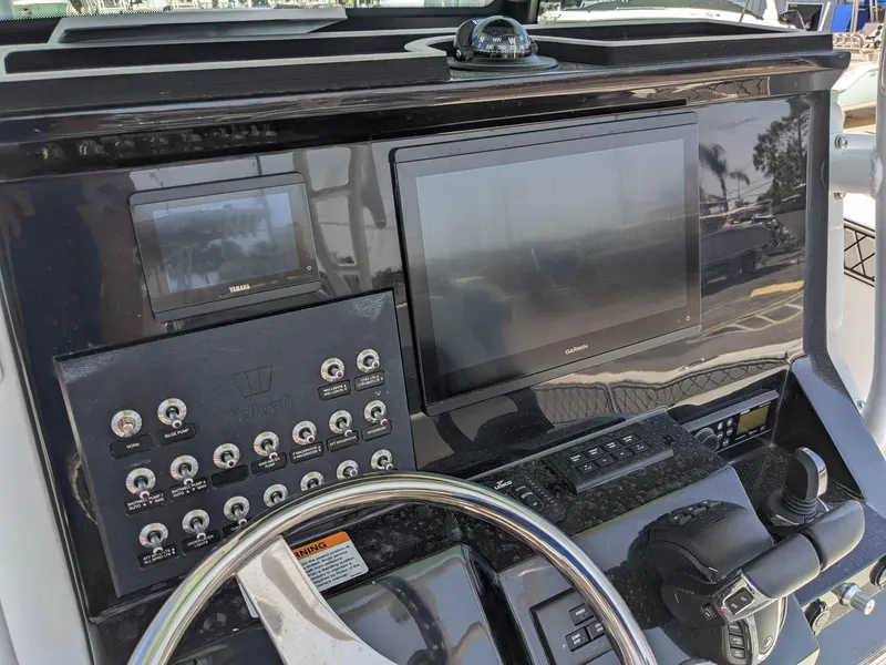 Slide: The Image of Control panel of 2024 Wellcraft 302 Fisherman boat with navigation screens and steering wheel. - 9