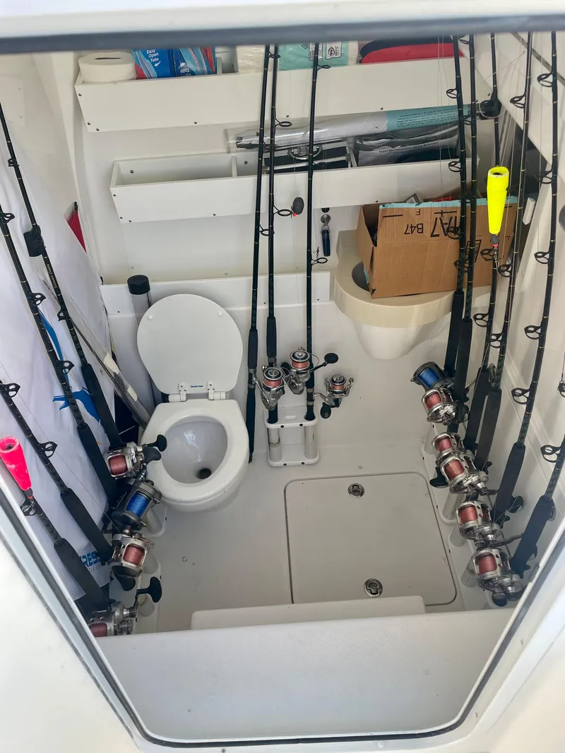 Slide: The Image of 2019 Invincible 39 Open Fisherman boat interior with fishing rods and toilet. - 12