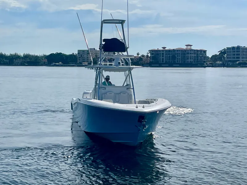 Slide: The Image of 2019 Invincible 39 Open Fisherman boat on calm water near coastal buildings. - 20