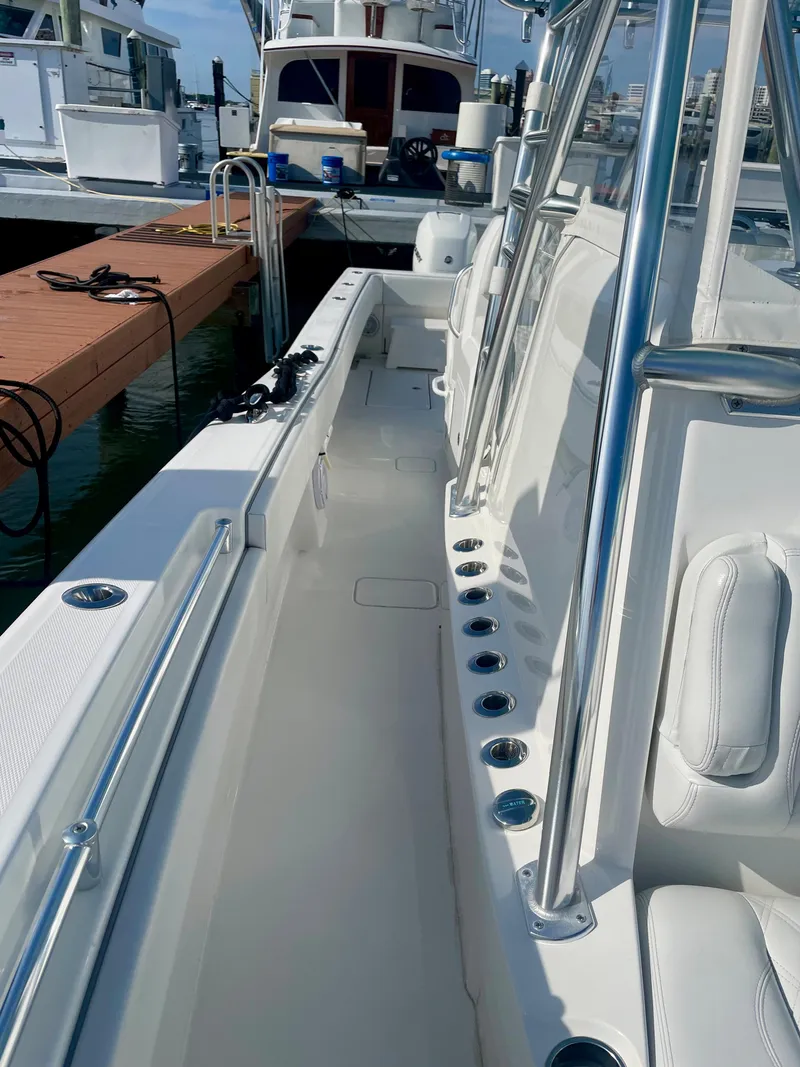 Slide: The Image of 2019 Invincible 39 Open Fisherman boat docked, showcasing spacious deck and seating area. - 4