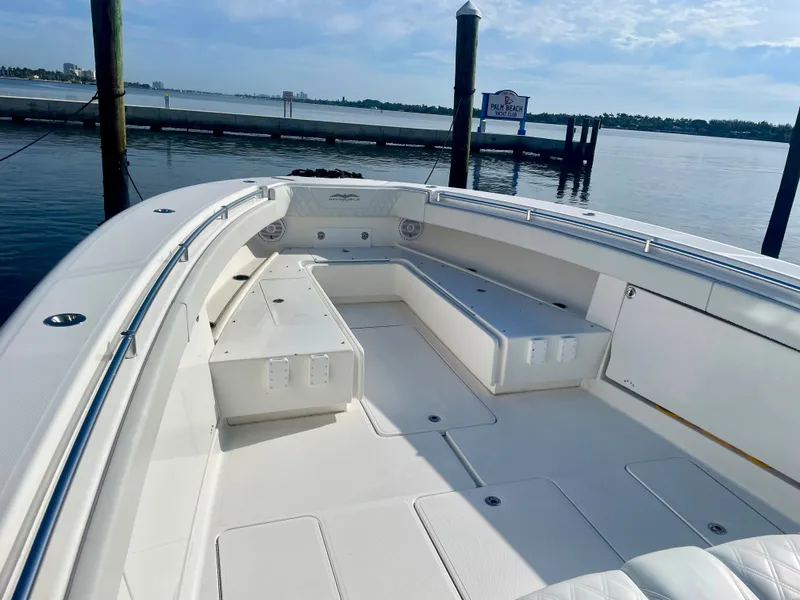 Slide: The Image of 2019 Invincible 39 Open Fisherman boat docked, showcasing spacious seating and storage. - 7