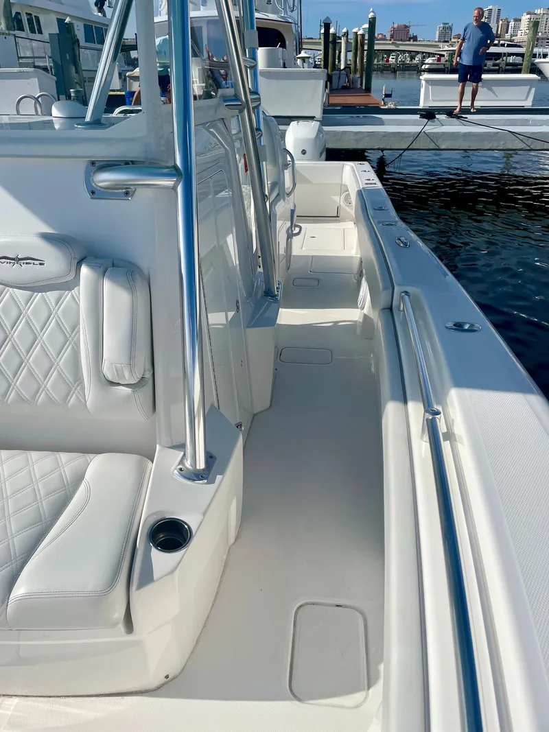 Slide: The Image of 2019 Invincible 39 Open Fisherman boat docked, showcasing spacious deck and seating. - 8
