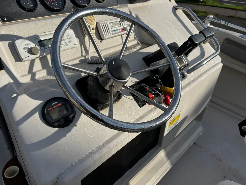 Slide: The Image of 1988 Sea Ray Laguna 23 boat steering console with gauges and controls. - 10