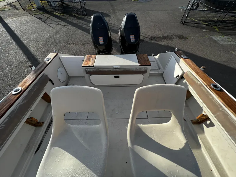Slide: The Image of 1988 Sea Ray Laguna 23 boat interior with dual outboard motors. - 13