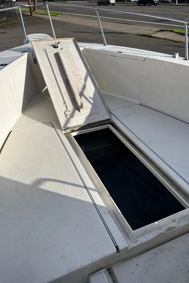 Slide: The Image of 1988 Sea Ray Laguna 23 boat with open storage compartment. - 21