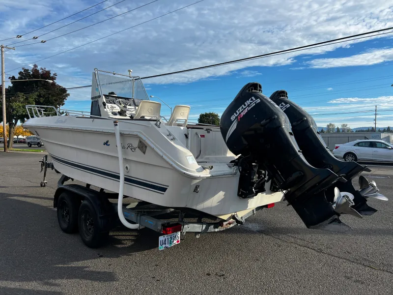 Slide: The Image of 1988 Sea Ray Laguna 23 boat on trailer with Suzuki outboard motors. - 4