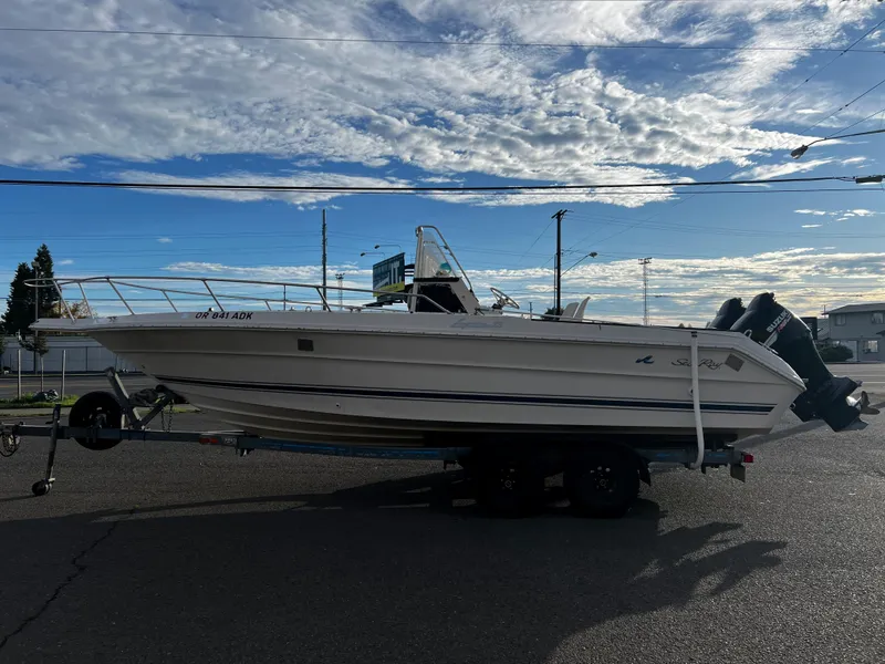Slide: The Image of 1988 Sea Ray Laguna 23 boat on trailer under a partly cloudy sky. - 5