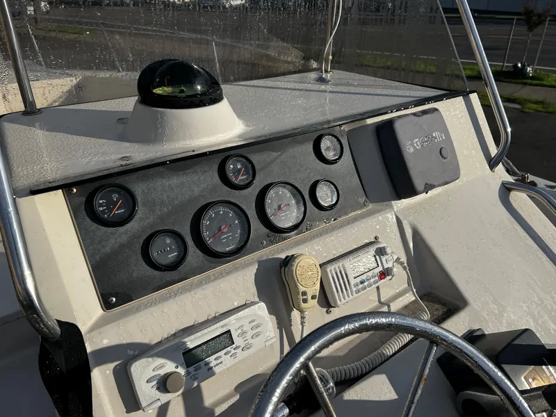 Slide: The Image of 1988 Sea Ray Laguna 23 boat dashboard with gauges and navigation equipment. - 9