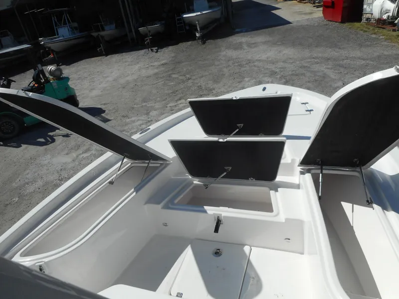 Slide: The Image of 2024 Sea Fox 251 BAYFOX boat with open storage compartments. - 13
