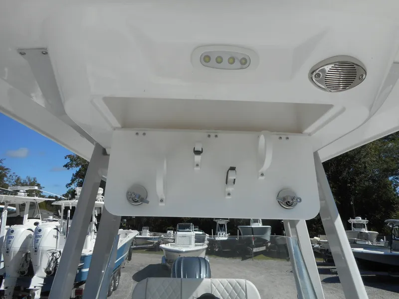 Slide: The Image of 2024 Sea Fox 251 BAYFOX boat interior with rod holders and overhead storage. - 19