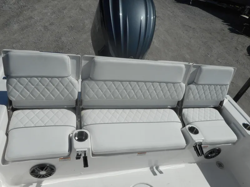 Slide: The Image of 2024 Sea Fox 251 BAYFOX boat with white cushioned seating and cup holders. - 7