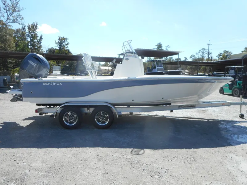 Slide: The Image of 2024 Sea Fox 231 BAYFOX boat on a trailer in a parking lot. - 1