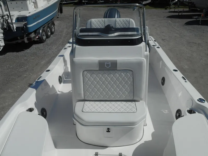 Slide: The Image of 2024 Sea Fox 231 BAYFOX boat interior with white cushioned seating and console. - 13