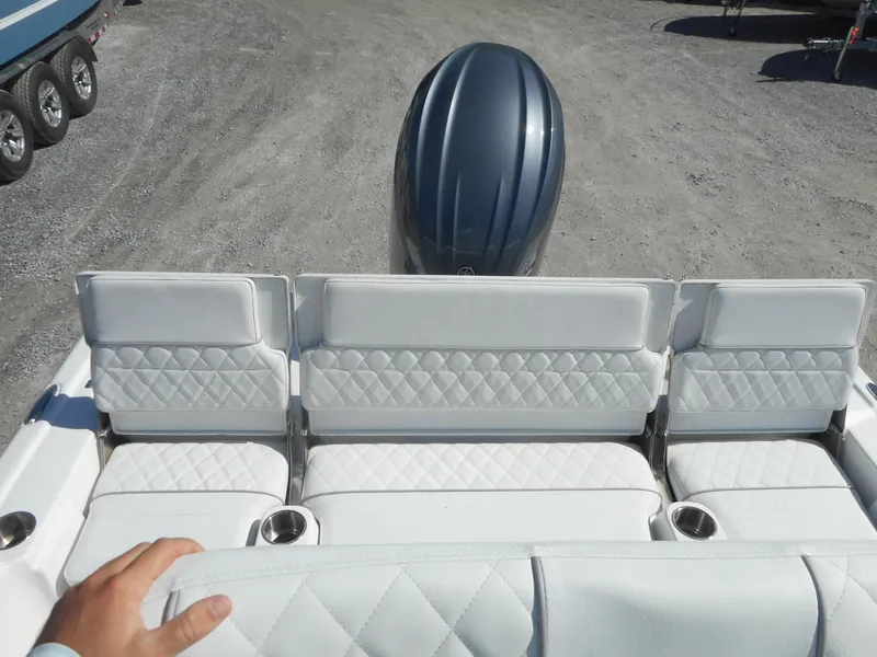 Slide: The Image of 2024 Sea Fox 231 BAYFOX boat with white cushioned seating and outboard motor. - 6